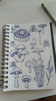 a notebook with drawings of mushrooms on it