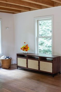 a living room with wooden floors and white walls