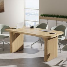 a wooden table sitting in the middle of a room next to chairs and a plant