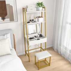 a white and gold shelving unit in a bedroom next to a window with curtains