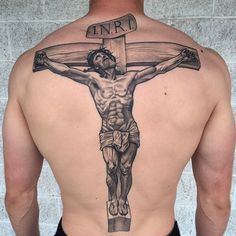 a man with a cross tattoo on his back