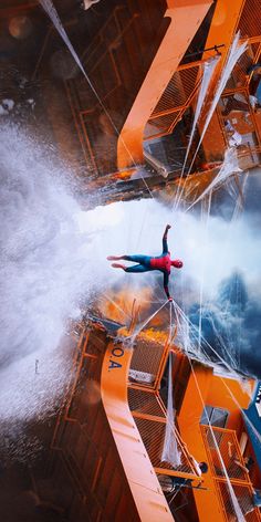 a man is in the air on a water slide