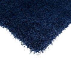 an area rug with dark blue shag on the bottom and white backgroud