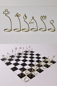 several pieces of metal wire sitting on top of a chess board