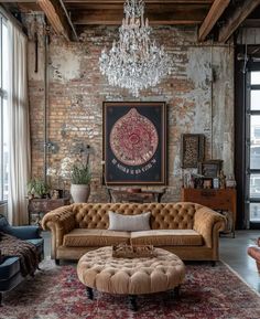 a living room filled with furniture and a chandelier hanging from the brick wall