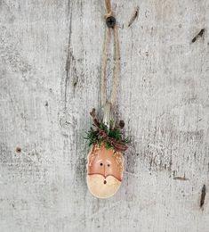 a wooden ornament hanging from a rope on a wall