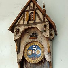 an old cuckoo clock hanging on the wall