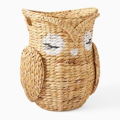 a wicker owl vase with eyes painted on it