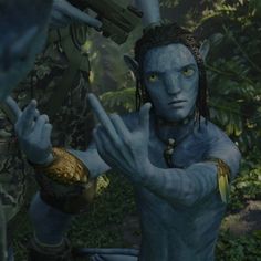 the avatar from avatar is holding his hands up in front of him and pointing to something