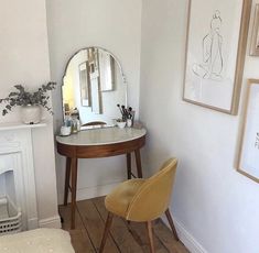 a room with a chair, mirror and fireplace