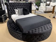 a black and white bed sitting on top of a carpeted floor in a room