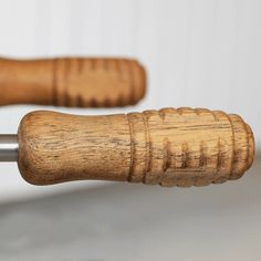 two wooden handlebars with metal tips on them