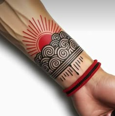 a person with a tattoo on their arm and wrist is holding up a red bracelet