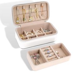 an open white suitcase with jewelry in it