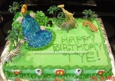 a birthday cake with animals and trees on it