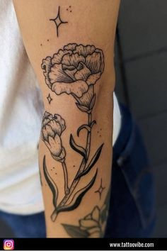 a woman's arm with flowers and stars on it