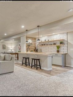 a living room filled with furniture next to a kitchen and dining area in a home