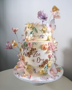 a wedding cake decorated with flowers and butterflies