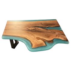 a wooden table that is made out of wood and blue glass on the top, with black metal legs