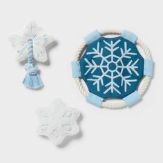 two snowflakes, one with a tassel and the other with an ornament