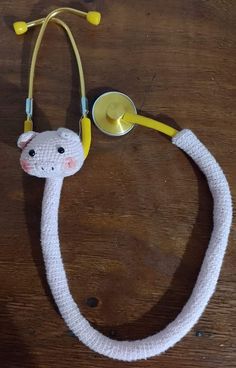 a knitted snake with a stethoscope attached to it's head