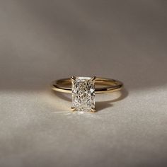 a gold ring with a princess cut diamond