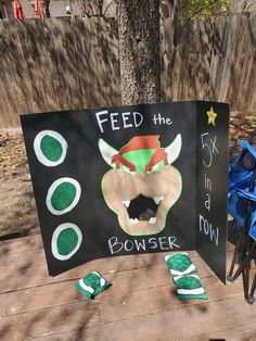 a sign that says feed the cowser on it next to a blue bike and tree