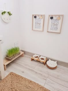 two cat beds with grass in them on the floor next to a toilet and sink