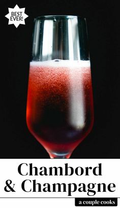 a close up of a wine glass on a table with the words champagne and cranberries