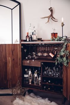 an old fashioned liquor cabinet is filled with glasses and other things to drink in it