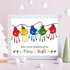 a christmas card with three lights hanging from it