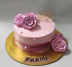 there is a cake with pink frosting and flowers on the top that says parm