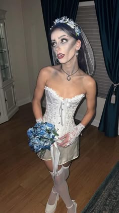 a woman dressed up as a bride holding a bouquet