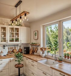 a kitchen filled with lots of counter top space next to a window covered in potted plants