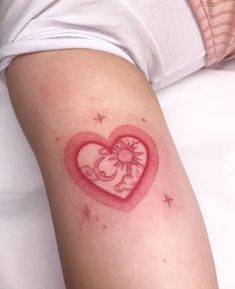 a heart shaped tattoo with an elephant on the inside of it's left arm