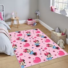 minnie mouse bedroom rug in pink with hearts and flowers on the floor next to a bed