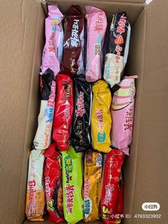 a box filled with lots of different types of candy in it's wrappers