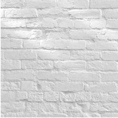 a white brick wall is shown in this black and white photo