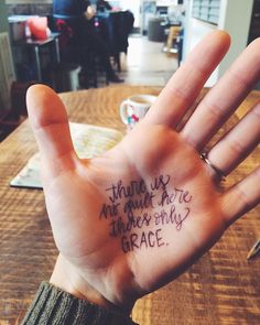 a person's hand with writing on it that says, thank us not going here there is only grace