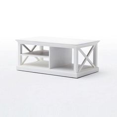 a white coffee table with two shelves on each side