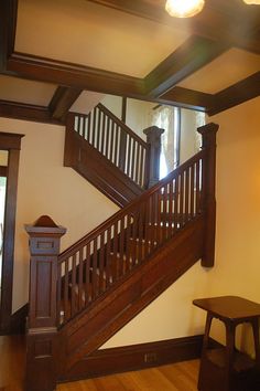 a wooden stair case next to a window in a room