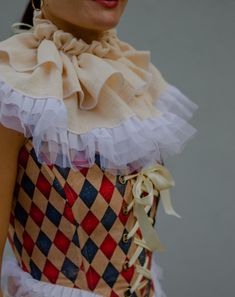 a woman wearing a dress with ruffles on it