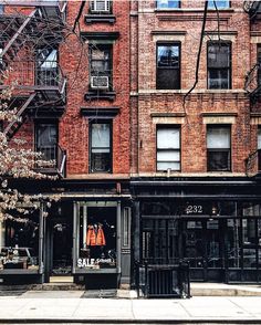 an old brick building on the corner of a street in front of a storefront