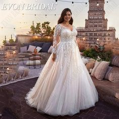 a woman in a wedding dress standing on a patio with lights strung overhead and the caption evon bridal