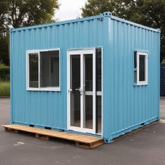 a blue shipping container sitting in a parking lot