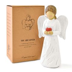 an angel figurine next to a box with the message you are loved on it