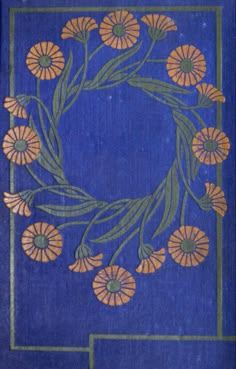 a blue book with orange flowers and green leaves in the center, on a blue background