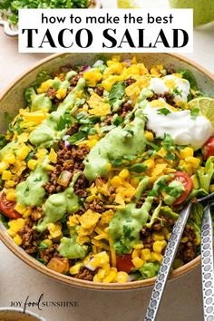 a bowl filled with taco salad and topped with avocado