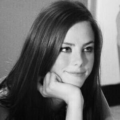 a black and white photo of a woman with long hair