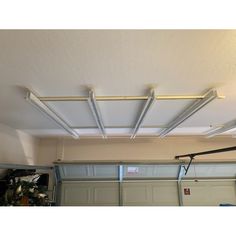 an overhead garage door is open to show the light fixture on the ceiling above it